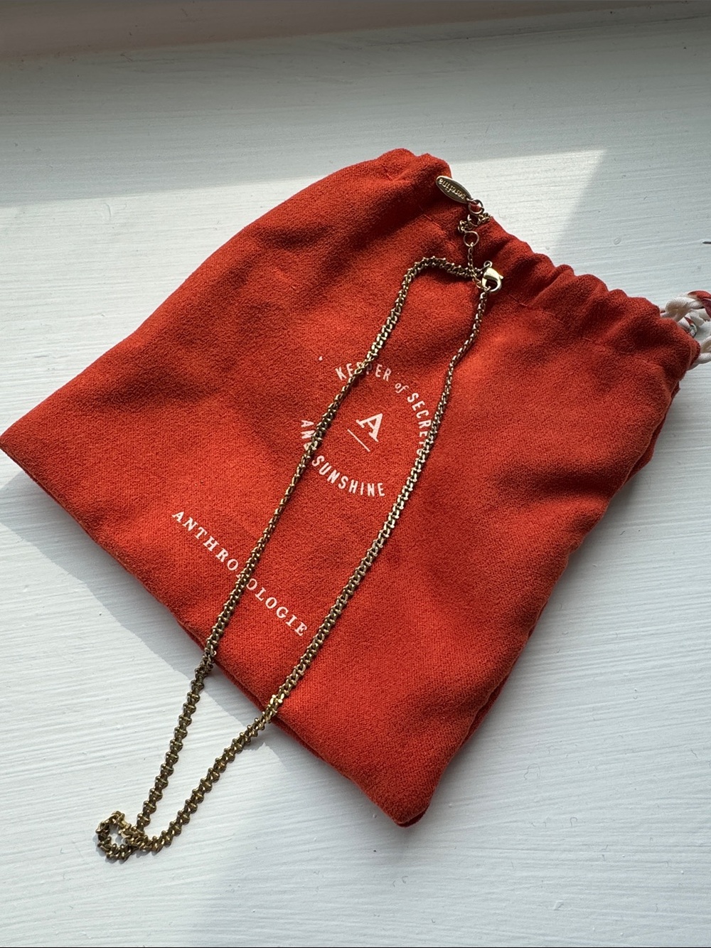Anthropologie Gold Chain Necklace with Rust-Orange Drawstring Pouch